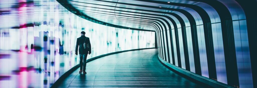 person walking along corridors